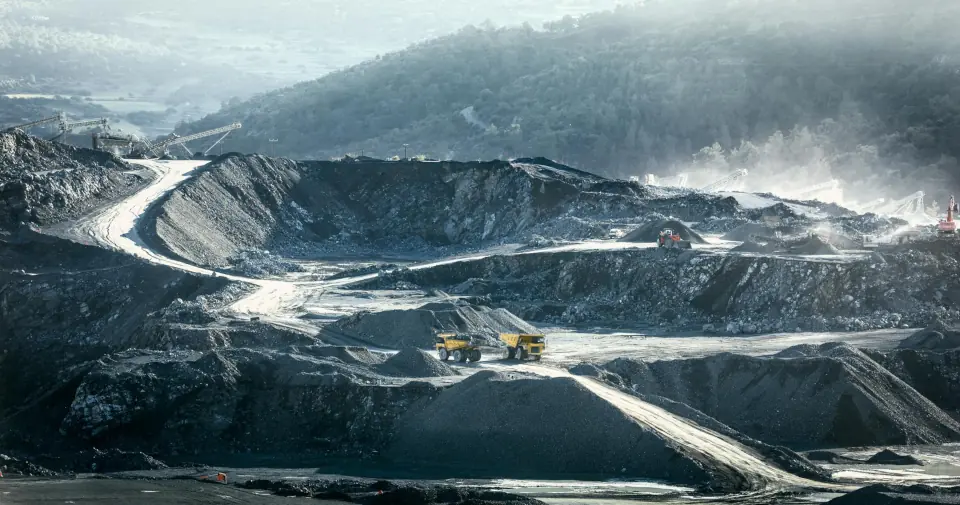 View of a mining site with heavy trucks.